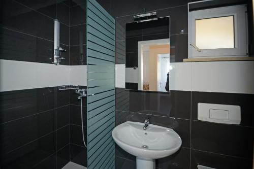 a bathroom with a sink and a mirror at Villa Zare in Poreč