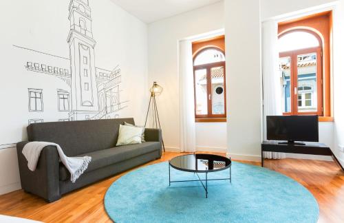 a living room with a couch and a table at Orpheus - Universidade - UNESCO Heritage in Coimbra