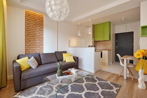 a living room with a couch and a table at JTB Nautica Aparthotel in Szczecin