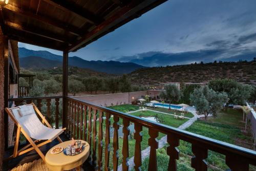 a room with a balcony with a chair and a view at Ouirgane Ecolodge in Ouirgane