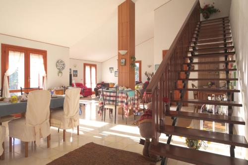 a living room with a staircase and a dining room at Magma Guest House in Ragalna