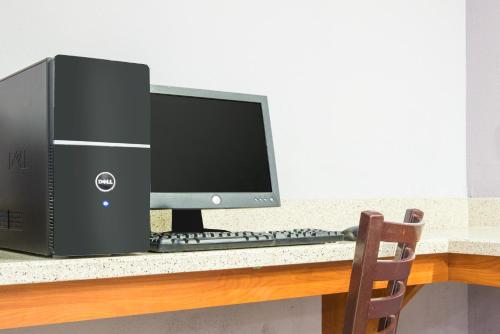 a computer monitor and keyboard on a desk at Super 8 by Wyndham Wichita South in Wichita