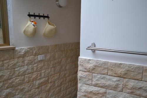 a bathroom with a tiled shower with two bags at b&b Green Valley in Salerno