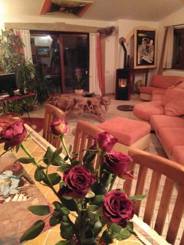 a living room with a table with roses on it at Casa d' Artista B&B in Ozieri