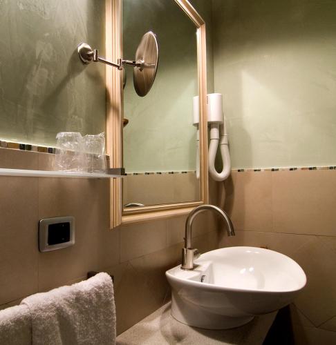 a bathroom with a toilet and a sink and a mirror at Lokanda Devetak in Savogna dʼIsonzo