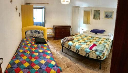 a bedroom with a bed and a desk in it at Casa Ai Piedi Della Riserva Naturale in Pettorano sul Gizio