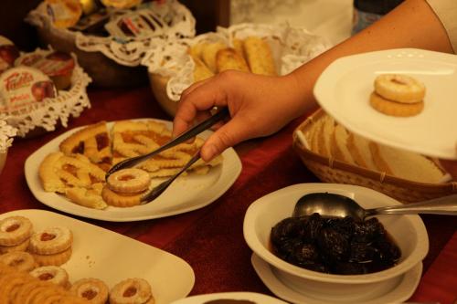 a person holding a spoon over a table of food at Santa San in Champoluc