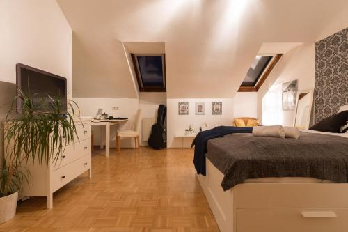 a bedroom with a bed and a desk and a television at Studio Vienna Central Station in Vienna