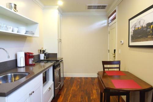 a kitchen with a sink and a wooden table in a room at Hotel Mac in Richmond