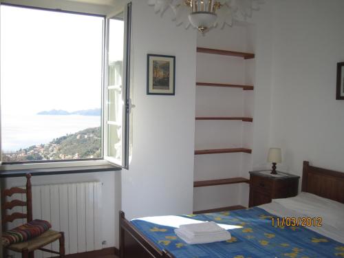 a bedroom with a bed and a large window at Affittacamere Cerisola 2003 in Zoagli