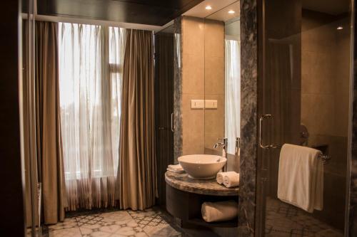 a bathroom with a sink and a toilet in it at Regency Tirunelveli By GRT Hotels in Tirunelveli