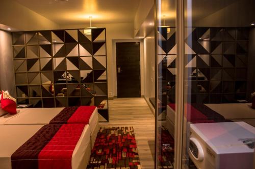 a bedroom with a bed and a walk in shower at Regency Tirunelveli By GRT Hotels in Tirunelveli