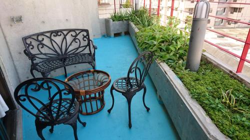 three benches sitting on top of a balcony at Kokusai Towns Inn in Naha