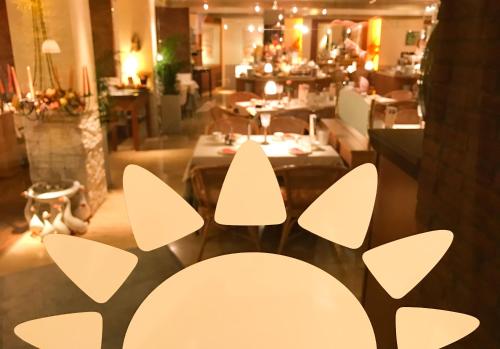a dining room with white chairs and a table at City Hotel Ost am Kö in Augsburg