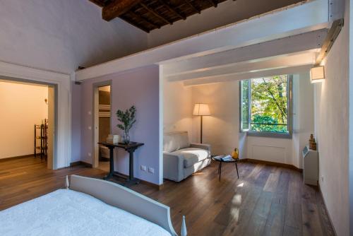 a bedroom with a bed and a couch and a window at La Milzetta in Russi