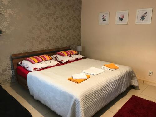 a bedroom with a bed with towels on it at Penzion Pohoda in Lednice