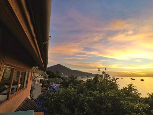 a view of a beach at sunset from a building at DD Hut Koh Tao in Koh Tao
