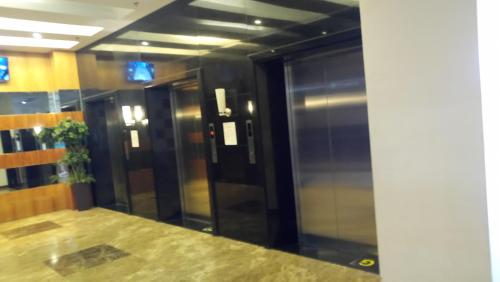 een lobby met een glazen lift in een gebouw bij Standard Room with Balcony 1569 in Tagaytay