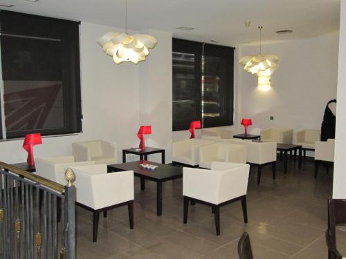 a dining room with white chairs and tables at Don Juan in Granada