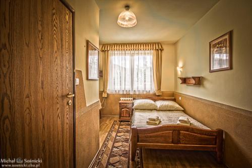 a bedroom with two beds and a window at Pensjonat Szczebel in Mszana Dolna