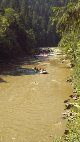 a group of people are rafting down a river at Friendly House in Kolomyya