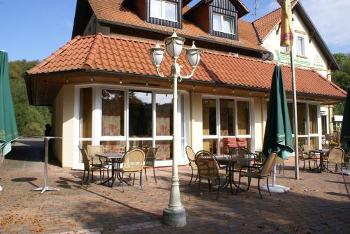 a house with a table and chairs and a street light at Hotel Elfenberg in Schieder-Schwalenberg