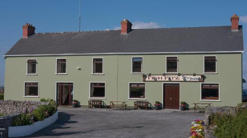 a large green building with a sign on it at Tigh Fitz Apartments - Inis Mór, Aran Island in Inis Mor