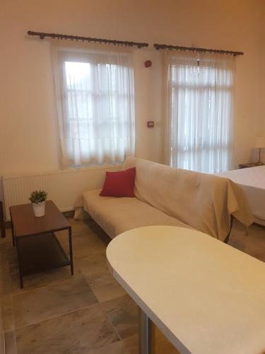 a living room with a couch and a bed at Kalopanayiotis Museum Inn in Kalopanayiotis