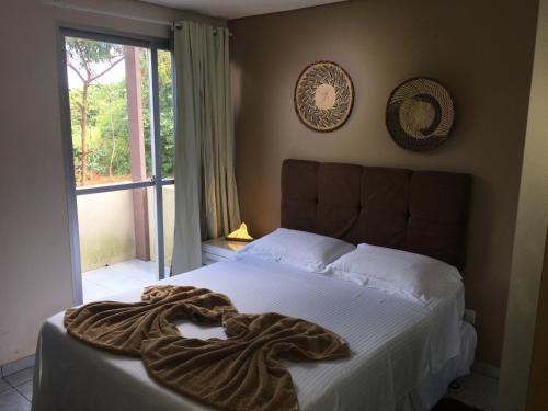 uma cama com um cobertor em um quarto em Farol da Rata em Fernando de Noronha