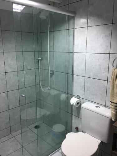 um banheiro com box de vidro e vaso sanitário em Farol da Rata em Fernando de Noronha