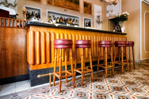 a group of stools at a bar at Hotel Ercolini & Savi in Montecatini Terme