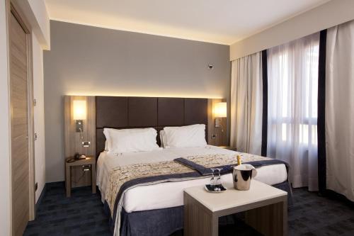 a hotel room with a large bed and a window at Best Western Plus Borgolecco Hotel in Arcore