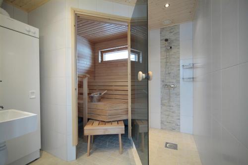 a bathroom with a shower and a toilet and a sink at Holiday Club Himos Apartments in Jämsä