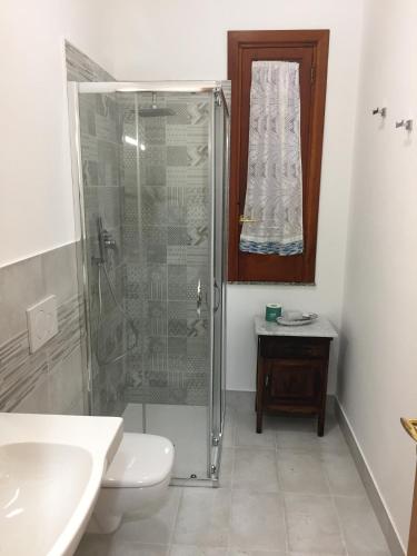 a bathroom with a shower and a toilet and a sink at Colapesce in Santa Teresa di Riva