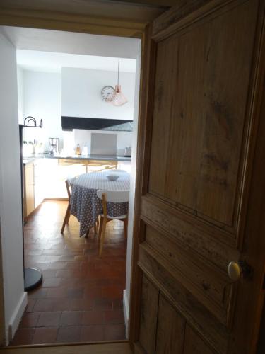 a kitchen and dining room with a table and a room at Gite de l'Abbaye d'Etrun in Étrun