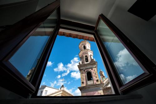 a view of a clock tower through a window at B&B La Chiave in Vietri sul Mare