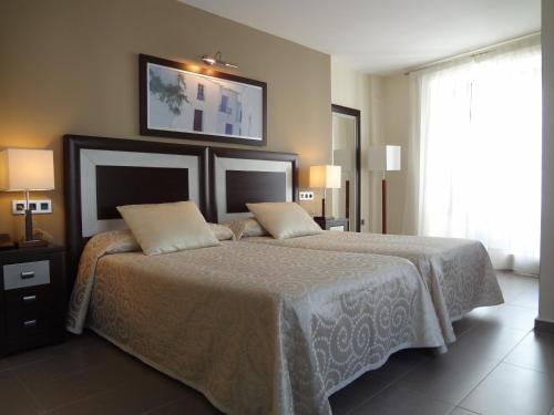 Hotel Rural Real de Poqueira tesisinde bir odada yatak veya yataklar
