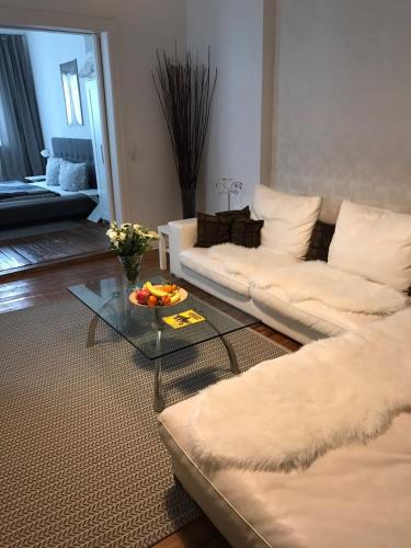 a living room with a white couch and a glass table at Bremer Viertel in Bremen