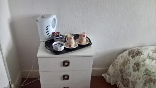 a nightstand with a blender on it next to a bed at Rhymney House hotel in Caerphilly