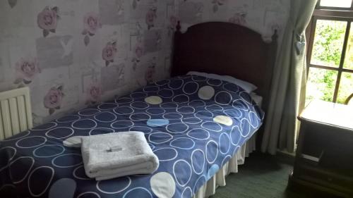 
A bed or beds in a room at Rhymney House hotel
