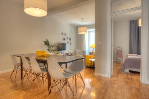 a dining room with a table and chairs at Angel's Duplex Terrace Five Bedrooms in Lisbon