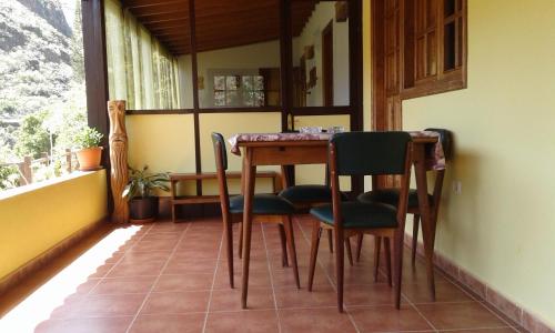 mesa y sillas en una habitación con ventana en Casa Rural Rincón del Olivo, en Lomito Fragoso y Honduras