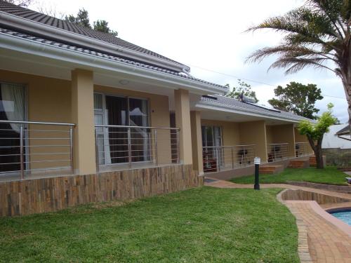 a house with a swimming pool in front of it at TeBeacon Accommodation in East London