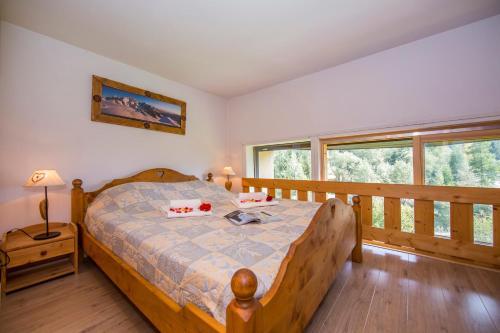 ein Schlafzimmer mit einem Bett mit einem Holzrahmen in der Unterkunft Résidence Grand Roc - Bruyères 116 - Happy Rentals in Chamonix-Mont-Blanc