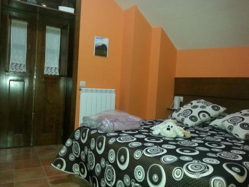a bedroom with a dog laying on a bed at Casa rural Rosita in Santa Cruz de los Cuérragos