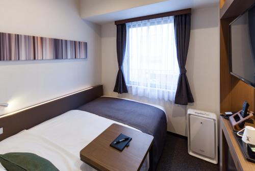 Ένα ή περισσότερα κρεβάτια σε δωμάτιο στο Y's HOTEL Shin Osaka