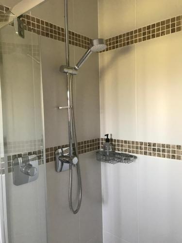 a bathroom with a shower with a glass door at Fair View in Marden