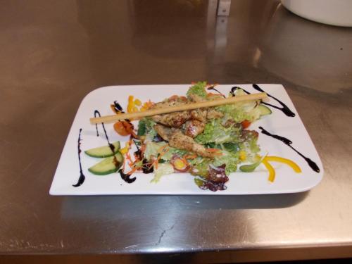 a plate of food with chopsticks on a table at Hotel Lohninger-Schober 3 Stern Superior in Sankt Georgen im Attergau
