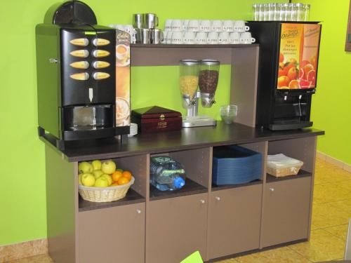 a counter with a coffee maker and fruit on it at La Sterne in Saint-Gilles-Croix-de-Vie