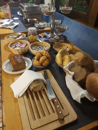 a table with bread and other foods on it at Hotel Eremitage in Arlesheim